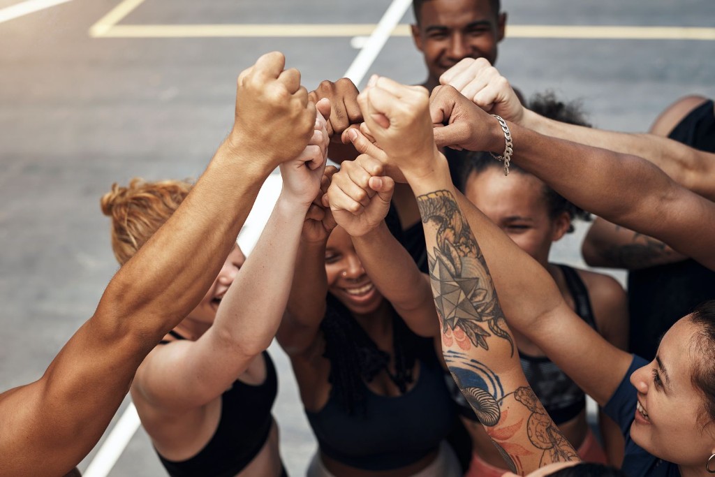 Team huddle with hands joined in unity